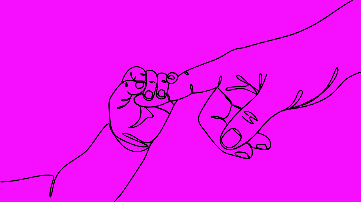Baby gripping adult finger
