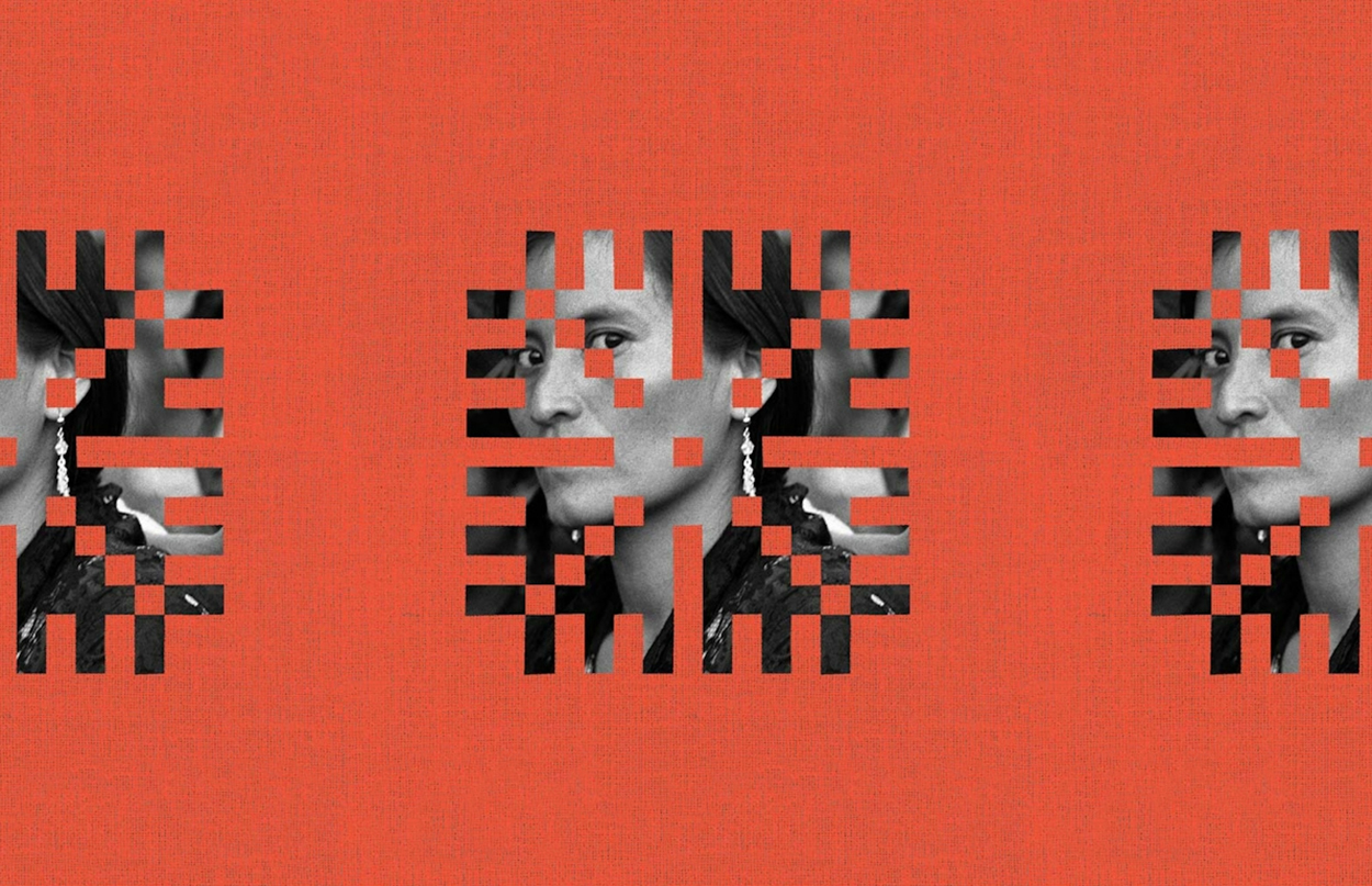 Black and white woman looking through orange design.jpg