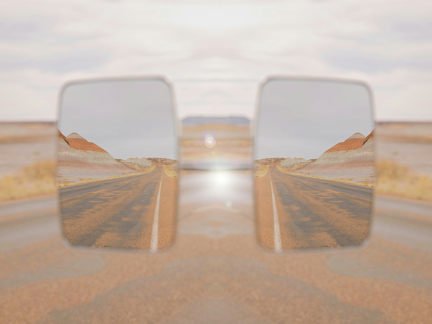 Car Mirror in Desert Landscape