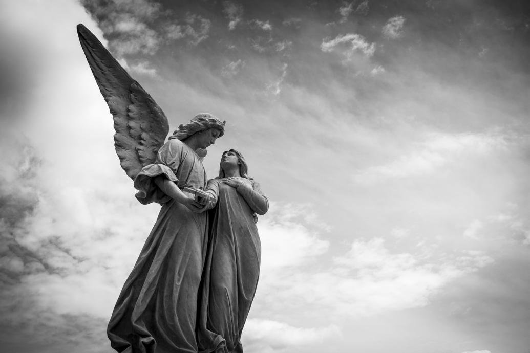 Two angel statues facing one another. 