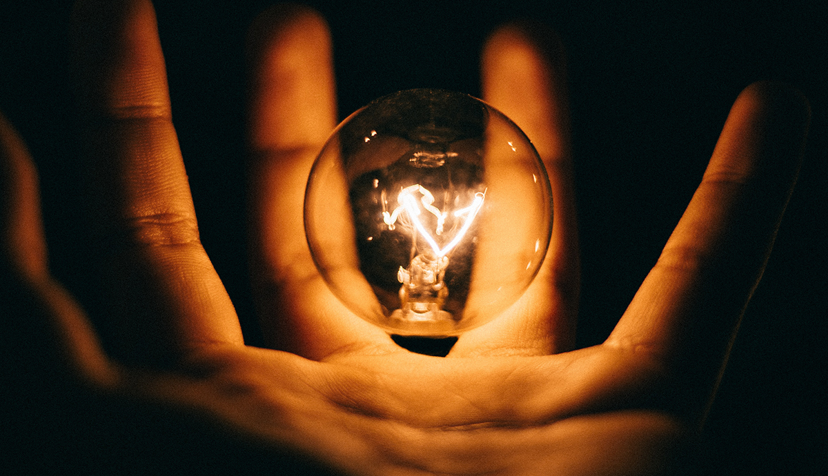 Header Graphic: A hand holding a floating incandescent lightbulb | Image Credit: Rohan Makhecha via Unsplash