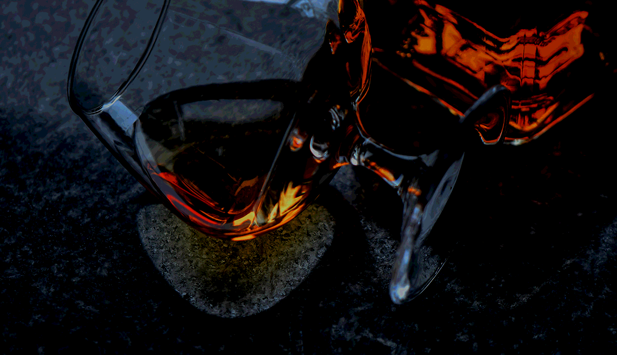 Header Graphic: Glass of deep ruby bourbon on its side | Image Credit: Pexels