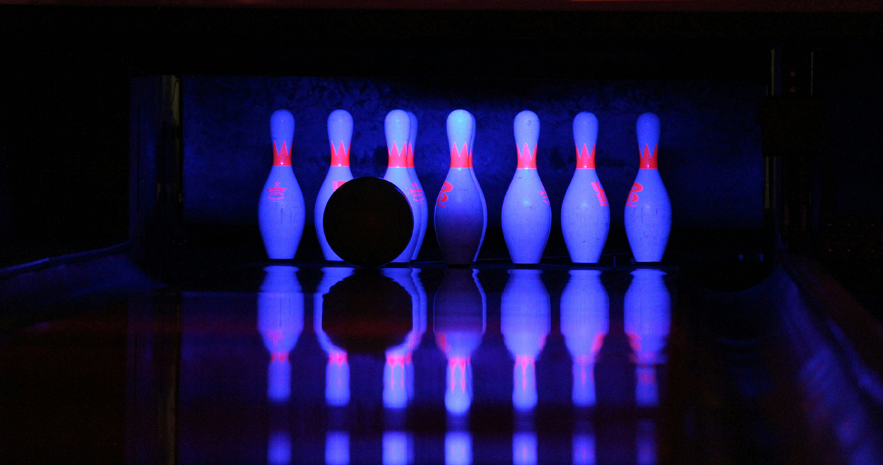 Bowling pins with a bowling ball in front of them