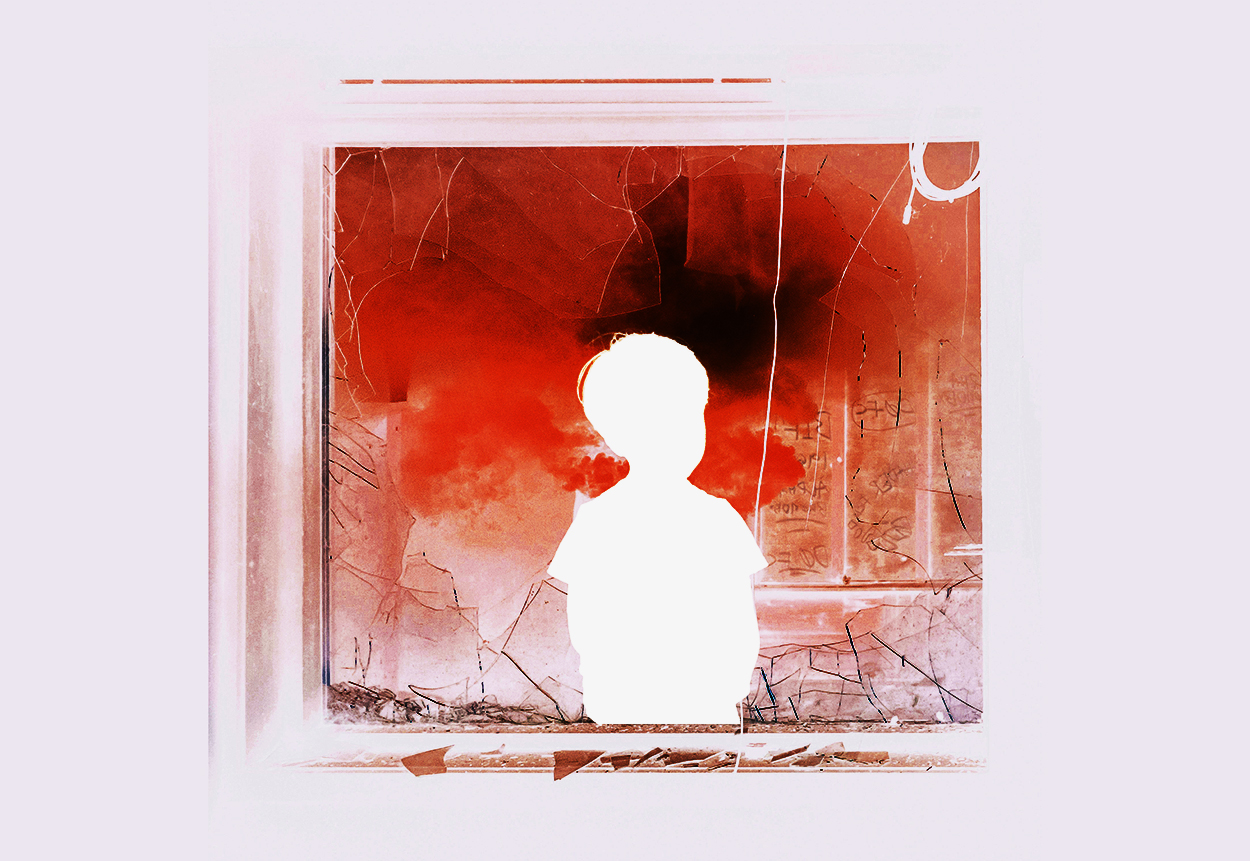 boy in broken window with red smoke