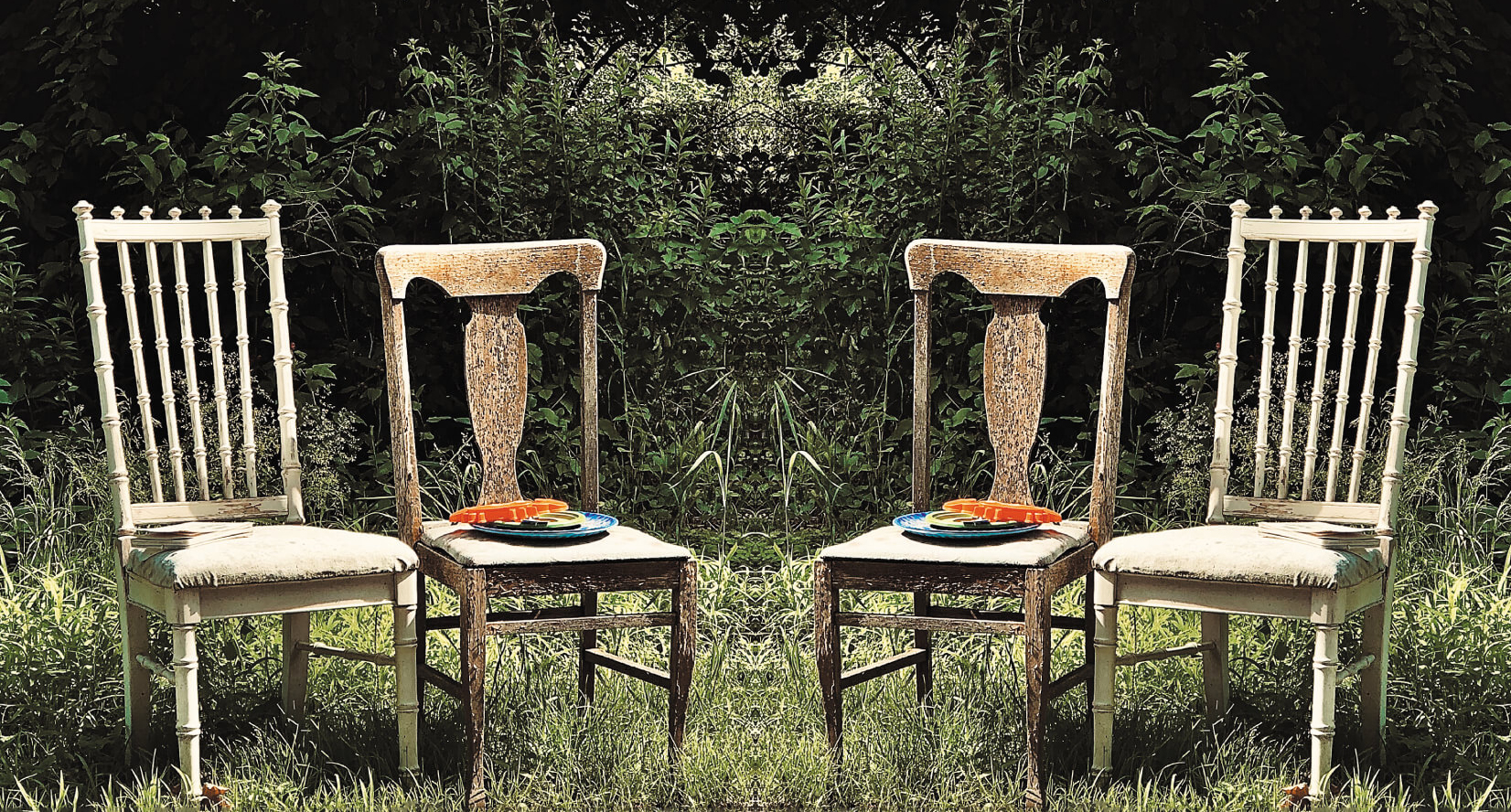 four wooden chairs outside in grass