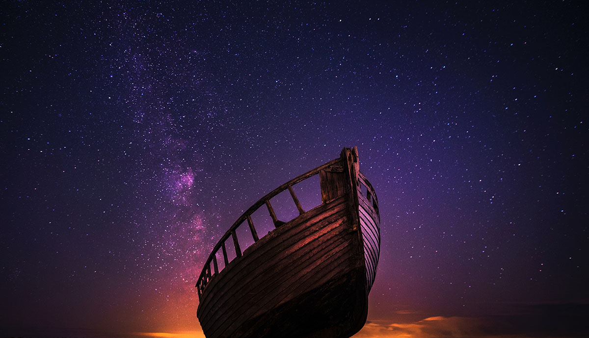 Header Graphic: Simple rowboat appears to fly in an evening sky | Image Credit: Zoltan Tasi via Unsplash