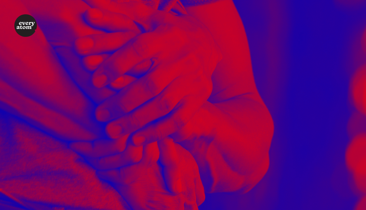 Red and blue hands holding one another