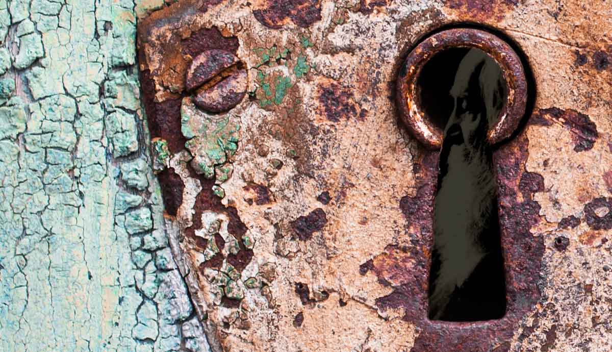 a rusty keyhole with whitman inside