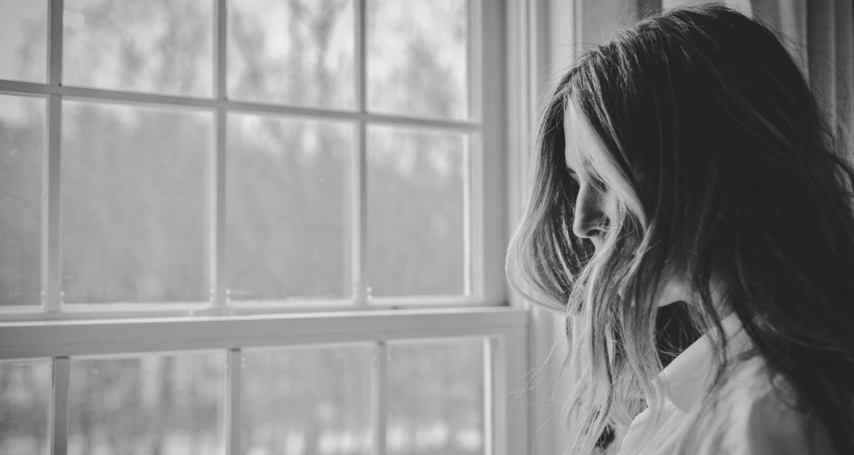 woman looking out a window