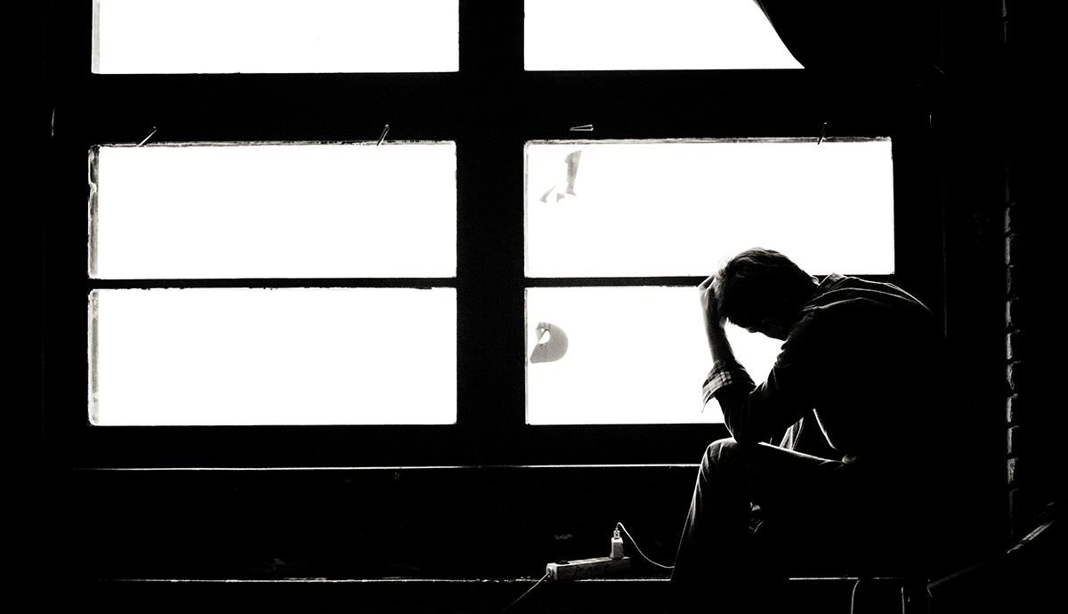 Header Graphic: Silhouette of a man sitting in front of a large window | Image Credit: Michal Matlon of Unsplash