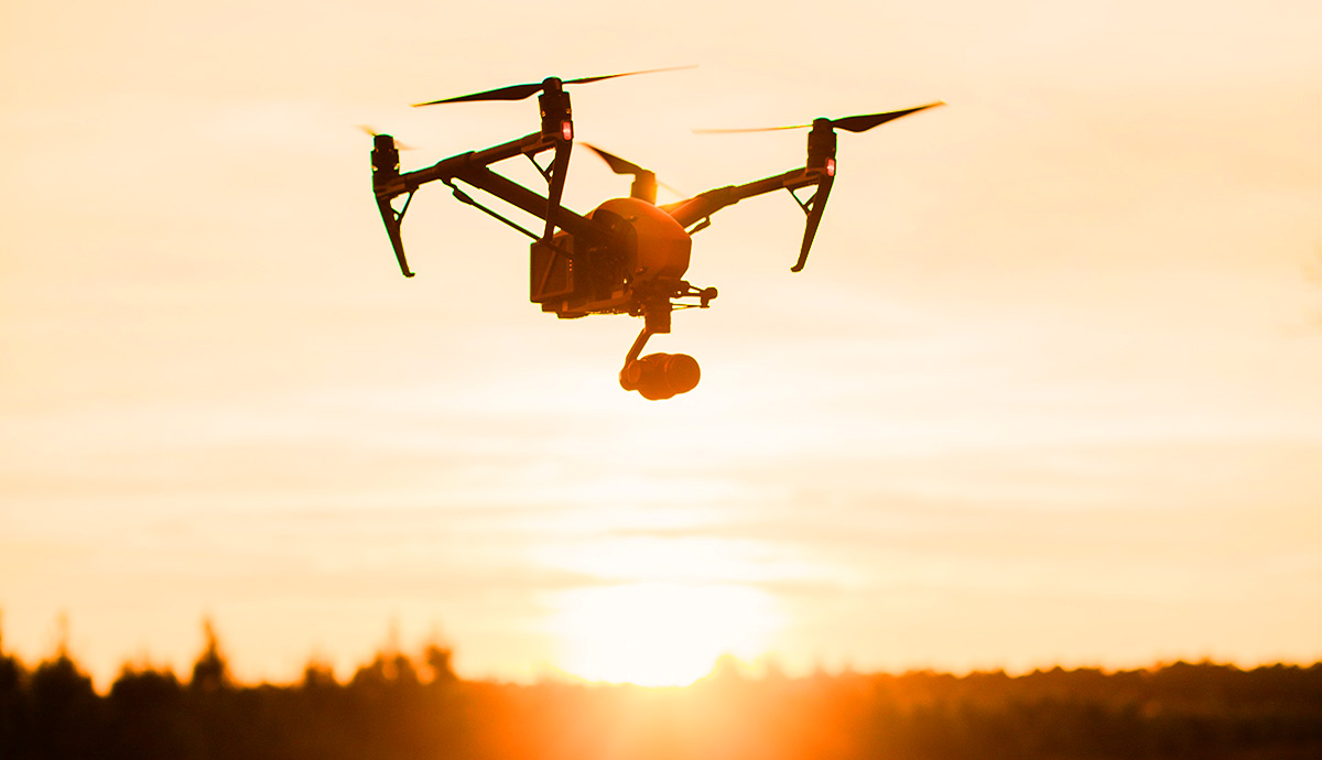 Header Graphic: A drone hovering during a sunset | Image Credit: Unsplash 