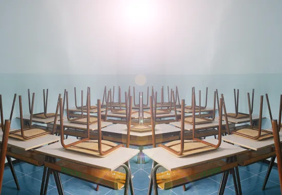 Empty classroom with chairs upside down on desks