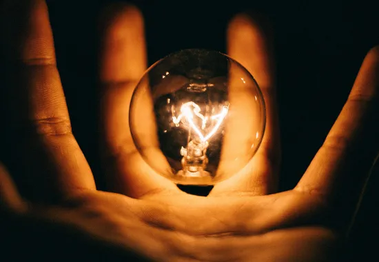 Header Graphic: A hand holding a floating incandescent lightbulb | Image Credit: Rohan Makhecha via Unsplash