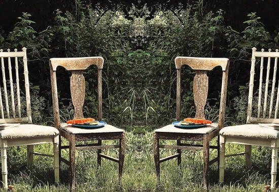 four wooden chairs outside in grass
