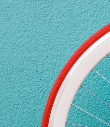 bicycle wheel against blue wall by Alessandra Caretto for Unsplash