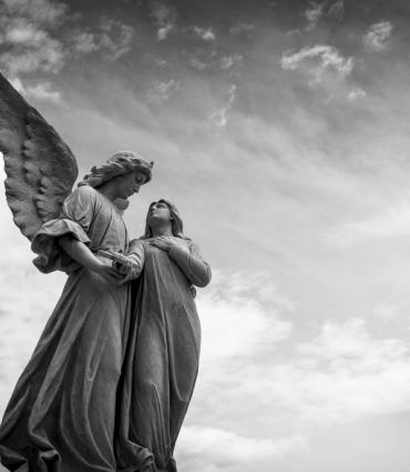 Two angel statues facing one another. 