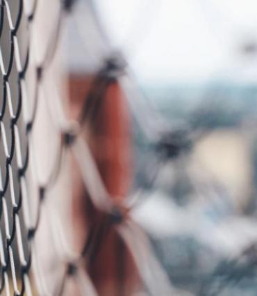 selective focus photo of a fence courtesy of Unsplash