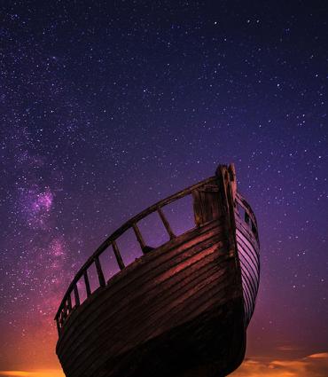 Header Graphic: Simple rowboat appears to fly in an evening sky | Image Credit: Zoltan Tasi via Unsplash