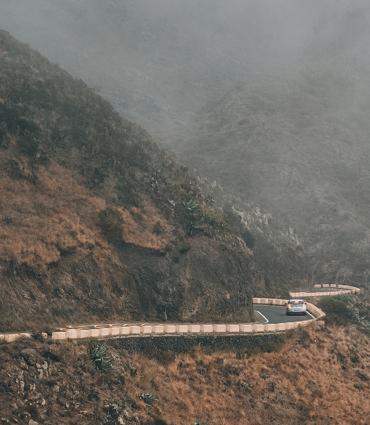 Header Graphic: Car driving on the edge of a steep mountainside | Image Credit: Majestic Lukas via Unsplash
