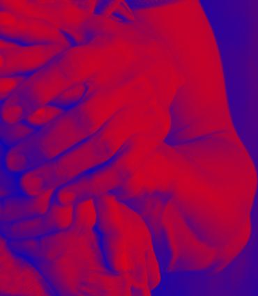 Red and blue hands holding one another