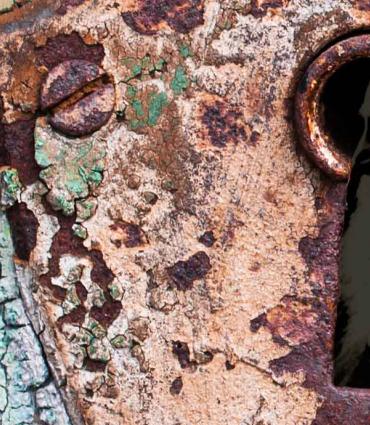 a rusty keyhole with whitman inside
