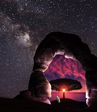 a colorful scene through a stone arch