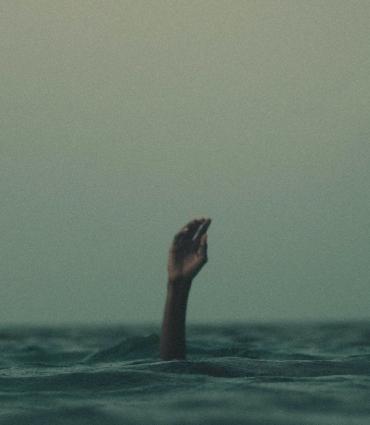 Header Graphic: Hand reaching out of waves | Unsplash: Mishal Ibrahim