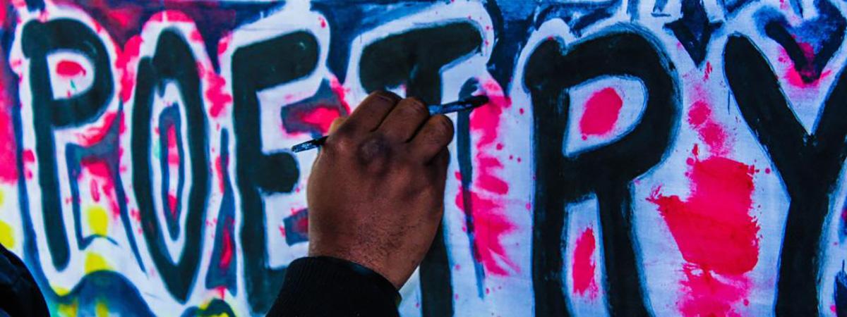 Header Graphic: Street artists painting the word "Poetry" | Image Credit: Unsplash