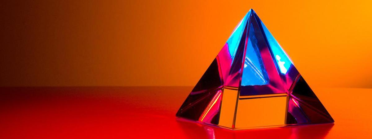 Header Graphic: Prism illuminated with a deep orange light | Image Credit: Unsplash