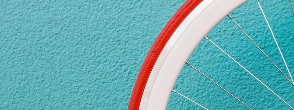bicycle wheel against blue wall