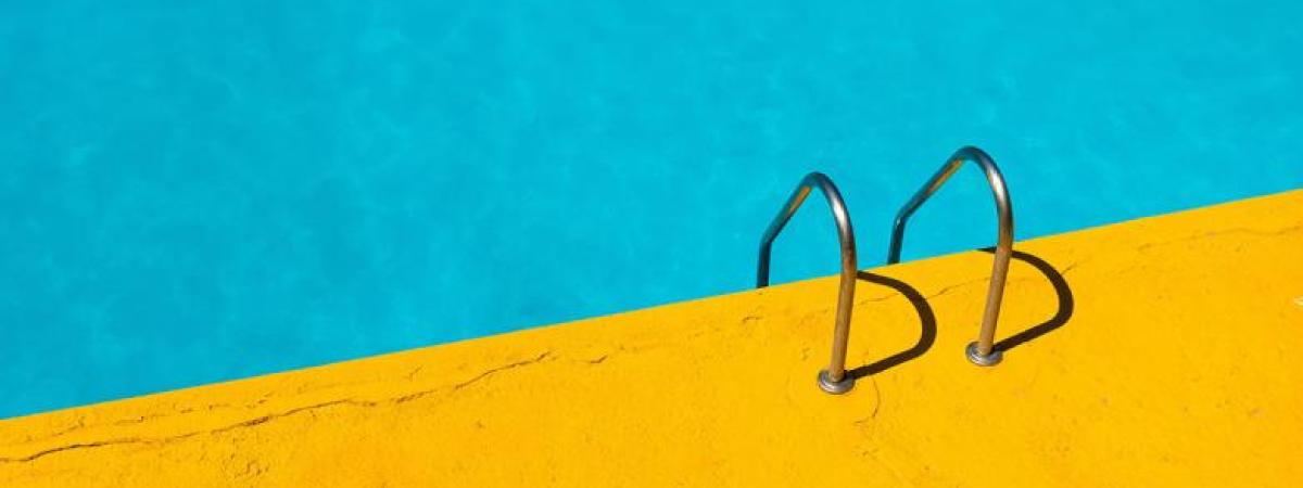 Header Graphic: Swimming pool with leader leading into the water | Image Credit: Unsplash