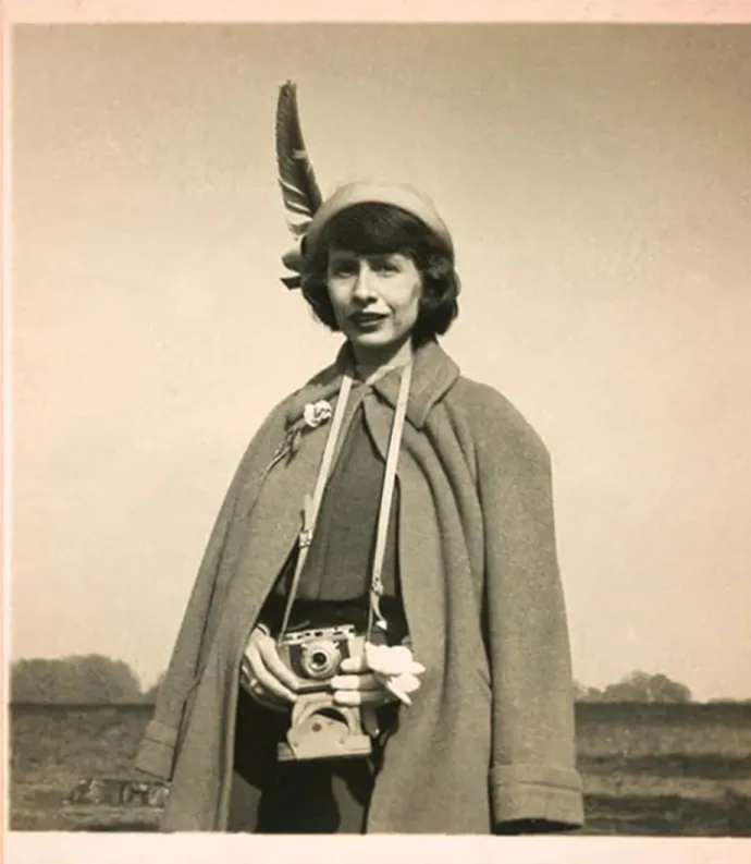 Amy Clampitt holding a camera