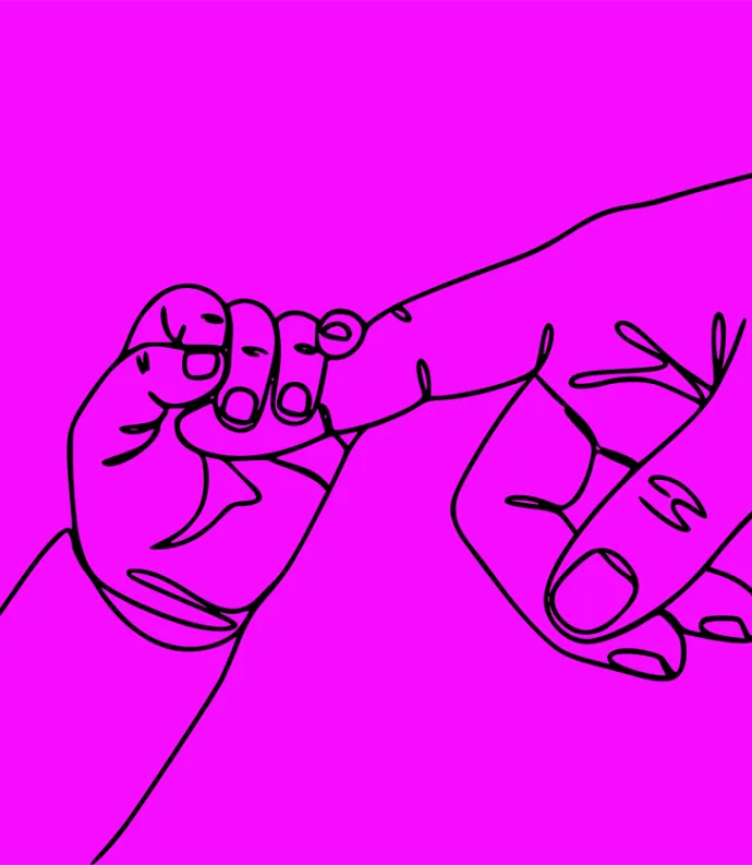 Baby gripping adult finger