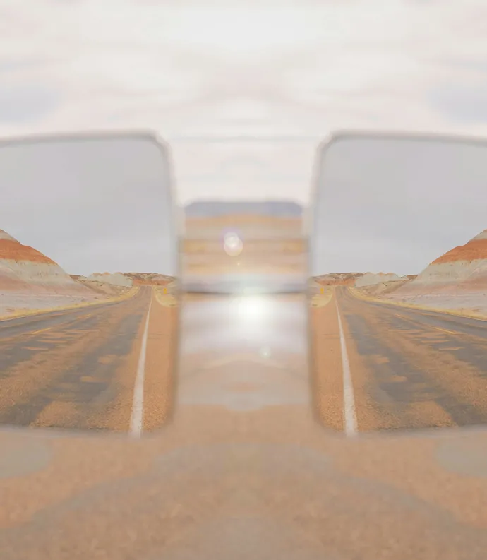 Car Mirror in Desert Landscape