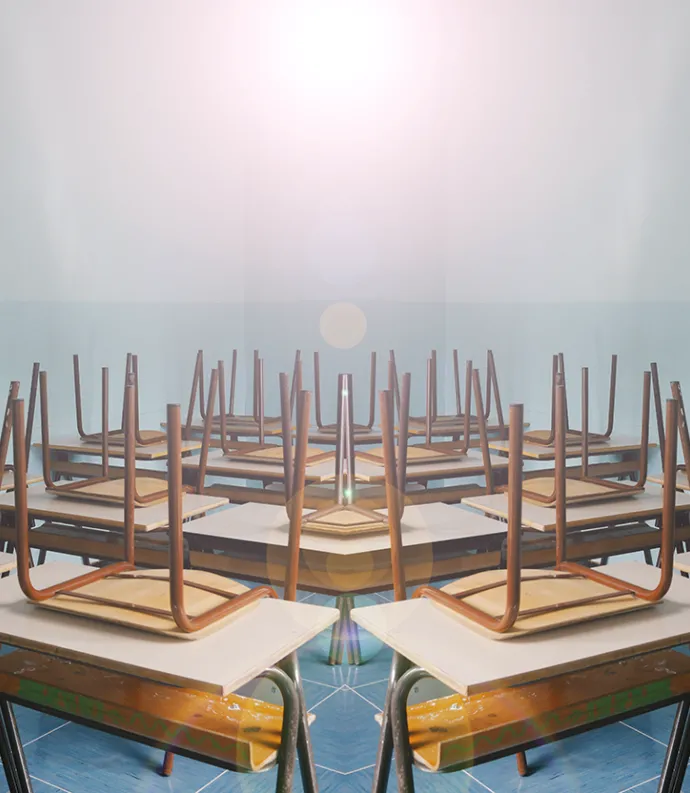 Empty classroom with chairs upside down on desks