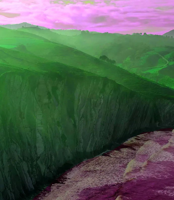 Green cliffs, violet ocean and sky