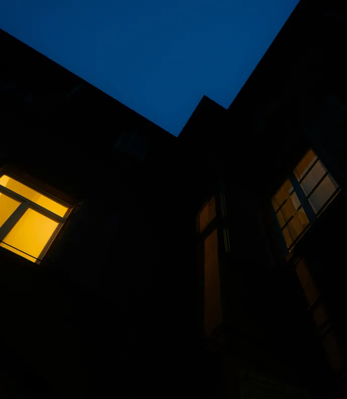 House with window lit up at night