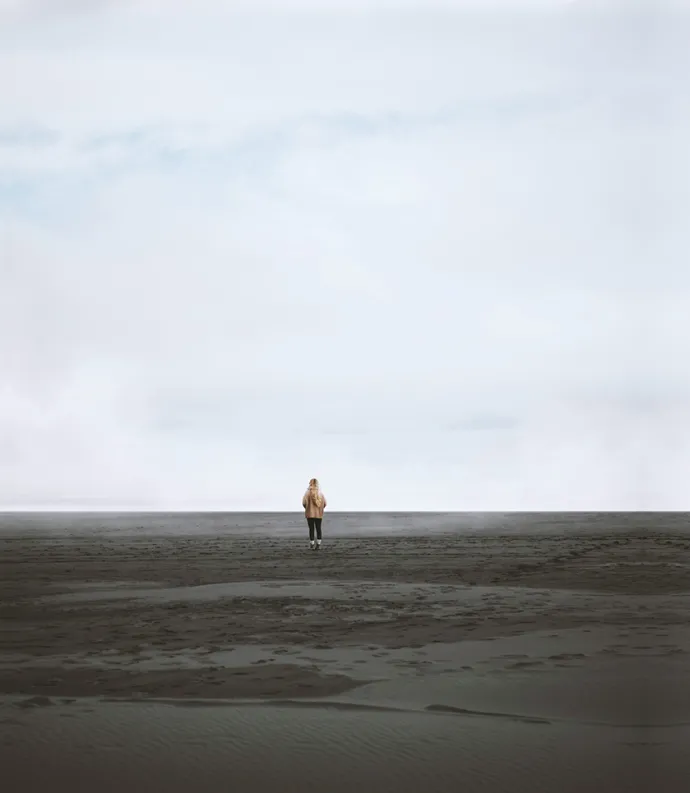 Person standing on empty beach