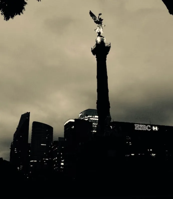 Angel, a photo by Nicolas Poynter. It shows a city and building with an angel sculpture on the tip.