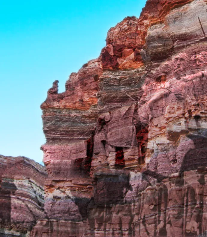 A cliff side with faint WWII imagery on it