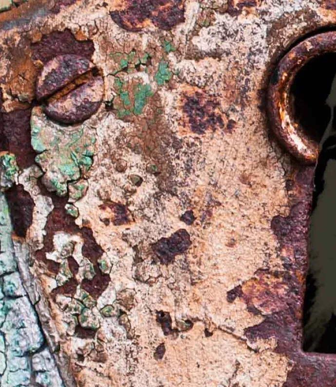 a rusty keyhole with whitman inside