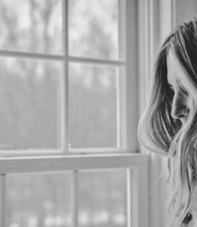woman looking out a window