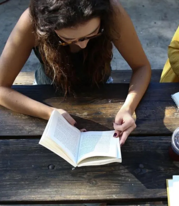 Image of women reading and writing at a table courtesy of Unsplash