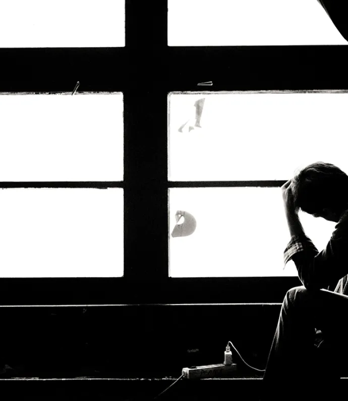 Header Graphic: Silhouette of a man sitting in front of a large window | Image Credit: Michal Matlon of Unsplash