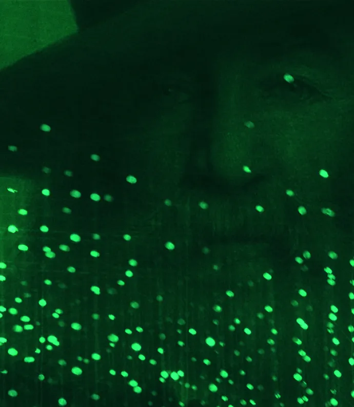 Whitman's face through green lights