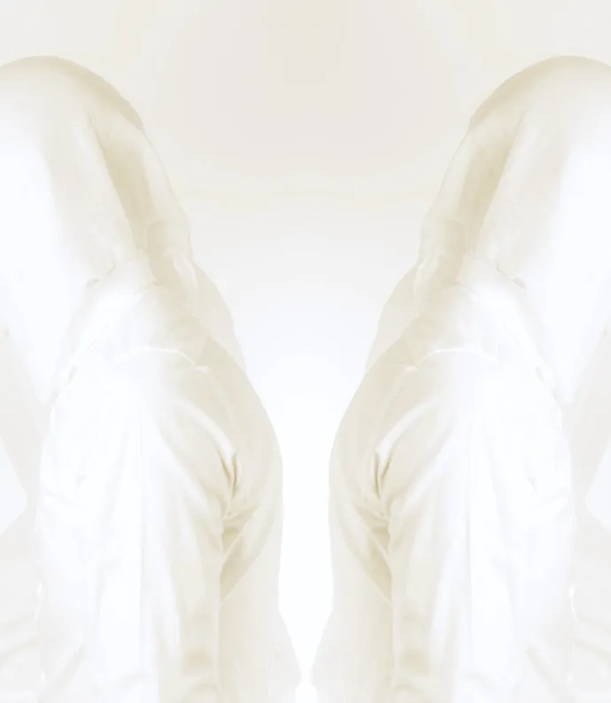 two figures in white facing away from each other